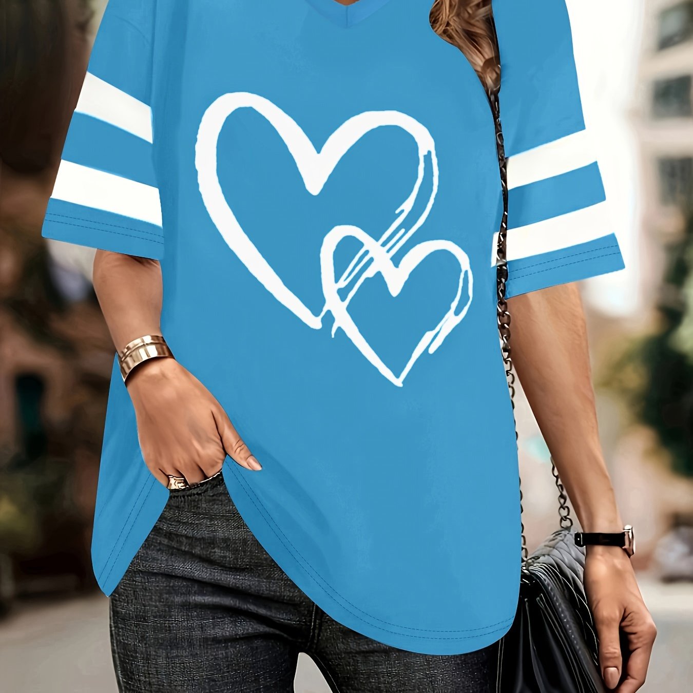 Plus-size blue V-neck tee with heart print and striped sleeves, casual knit fabric.