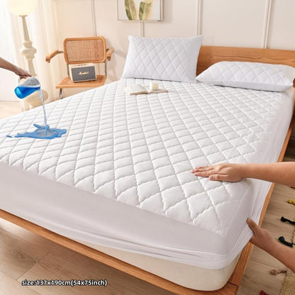 Waterproof quilted mattress protector cover in mixed color on a bed, showcasing spill resistance and ultra-soft comfort.