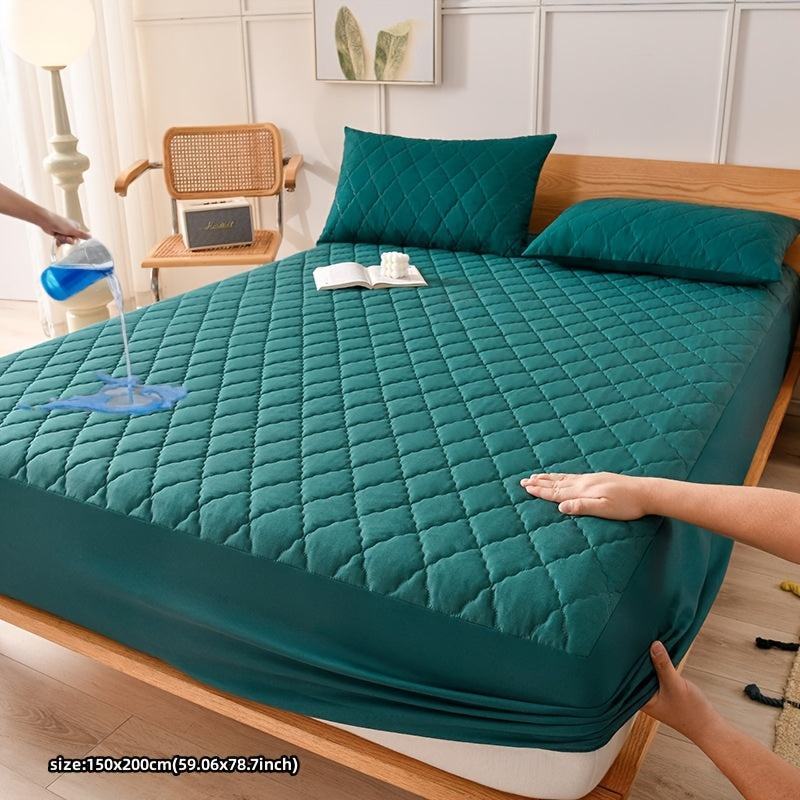 Waterproof fitted mattress protector cover on bed, quilted teal.