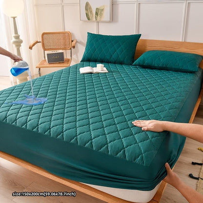 Waterproof fitted mattress protector cover on bed, quilted teal.